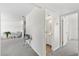 Neutral hallway featuring gray carpet, a bathroom and glimpse of the living area at 5213 Burr Pl, Seffner, FL 33584