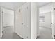 Hallway featuring doors leading to bedrooms with plush carpeting and bright natural light at 5213 Burr Pl, Seffner, FL 33584