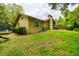 Side view of home featuring a backyard with a trampoline, screened in patio, and chimney at 5702 Ainsworth W Ct, Tampa, FL 33647