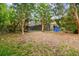 Spacious backyard with a black fence, screened-in patio, and lush green grass at 5702 Ainsworth W Ct, Tampa, FL 33647
