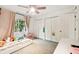 Bedroom with closet doors, light-blocking curtains, and bright natural light at 5702 Ainsworth W Ct, Tampa, FL 33647