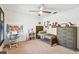 Bedroom with dark wood furniture, ceiling fan, and decorative wall decor at 5702 Ainsworth W Ct, Tampa, FL 33647