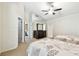 Spacious bedroom featuring a fan, mirrored dresser, and access to other rooms at 5702 Ainsworth W Ct, Tampa, FL 33647