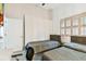 Bright bedroom features two twin beds, a window, desk and closet, creating a functional space at 5702 Ainsworth W Ct, Tampa, FL 33647