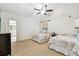 Comfortable bedroom with two beds, a ceiling fan, and a view into the bathroom at 5702 Ainsworth W Ct, Tampa, FL 33647