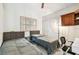Bedroom featuring two beds, closet, desk and shuttered window, offering a cozy retreat at 5702 Ainsworth W Ct, Tampa, FL 33647