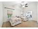 Spacious bedroom with two beds and a ceiling fan providing air circulation at 5702 Ainsworth W Ct, Tampa, FL 33647