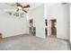 Bright room with high ceilings, a ceiling fan, built-in shelves, and natural light from the windows at 5702 Ainsworth W Ct, Tampa, FL 33647