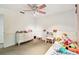 Bedroom featuring ceiling fan, carpet, and desk with furnishings at 5702 Ainsworth W Ct, Tampa, FL 33647