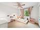 Bedroom with window, ceiling fan, and decorative features at 5702 Ainsworth W Ct, Tampa, FL 33647