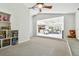 Open bonus room with built-in shelving, a window seat, and views into a connected living space at 5702 Ainsworth W Ct, Tampa, FL 33647