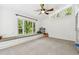 Versatile bonus room with a window seat, carpeted floor, and large windows overlooking the greenery at 5702 Ainsworth W Ct, Tampa, FL 33647