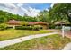 Lovely one-story home with a red tile roof, beautiful landscaping, and an inviting driveway at 5702 Ainsworth W Ct, Tampa, FL 33647