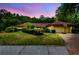 Charming single-story home with a well-maintained lawn and beautiful sunset sky at 5702 Ainsworth W Ct, Tampa, FL 33647