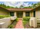 Inviting front entrance with a walkway, colorful shrubbery, and a tiled front patio at 5702 Ainsworth W Ct, Tampa, FL 33647