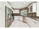 Well-appointed kitchen features granite countertops, stainless appliances, and tiled backsplash at 5702 Ainsworth W Ct, Tampa, FL 33647
