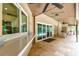 Spacious lanai with travertine tile flooring, outdoor bar, and views of the backyard and pool at 5702 Ainsworth W Ct, Tampa, FL 33647
