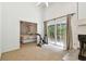 Bright living room with fireplace and sliding doors leading to the back yard, with view to bedroom at 5702 Ainsworth W Ct, Tampa, FL 33647