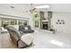 Spacious living room with a stone fireplace, skylight, ceiling fan, and a comfortable gray sectional sofa at 5702 Ainsworth W Ct, Tampa, FL 33647
