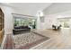 Spacious living area with a couch, dining table, and access to outdoor spaces through sliding glass doors at 5702 Ainsworth W Ct, Tampa, FL 33647