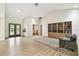 Open-concept living area with ample space, including a dining table and beautiful glass paneled doors at 5702 Ainsworth W Ct, Tampa, FL 33647