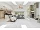 Bright living room with stone fireplace, ceiling fan, skylights, and easy access to the kitchen and pool area at 5702 Ainsworth W Ct, Tampa, FL 33647