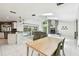 Open concept kitchen and living room with fire place, marble floors, and access to outdoor pool at 5702 Ainsworth W Ct, Tampa, FL 33647