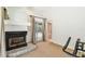 Living room featuring fireplace and sliding glass door to pool and porch at 5702 Ainsworth W Ct, Tampa, FL 33647
