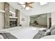 Spacious living room featuring a stone fireplace, ceiling fan, skylights, and an open layout at 5702 Ainsworth W Ct, Tampa, FL 33647