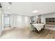 Spacious living room with wood floors, dining table, and lots of natural light at 5702 Ainsworth W Ct, Tampa, FL 33647