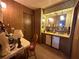 Retro bathroom featuring a dual sink vanity, wood paneling, and vintage floral wallpaper at 6099 107Th N Ave, Pinellas Park, FL 33782