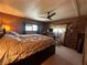 Inviting bedroom featuring a large bed, ceiling fan, and a window offering ample natural light at 6099 107Th N Ave, Pinellas Park, FL 33782