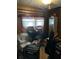Bedroom showcasing wood paneling, a window with curtains, and musical equipment for hobbies at 6099 107Th N Ave, Pinellas Park, FL 33782