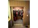 Walk-in closet with wood paneling and hanging clothes at 6099 107Th N Ave, Pinellas Park, FL 33782