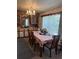 Charming dining area with a chandelier, ample cabinet storage, and a dining table at 6099 107Th N Ave, Pinellas Park, FL 33782