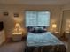 A calming bedroom featuring a comfy bed, ample lighting, and plenty of closet space for storage at 650 Pinellas Point S Dr # 101, St Petersburg, FL 33705