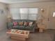 Cozy living room with a large window that offers plenty of natural light and a comfortable seating area at 650 Pinellas Point S Dr # 101, St Petersburg, FL 33705