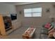 Relaxing living room featuring a sofa with decorative pillows, adjacent to a media center and decorative shelving at 650 Pinellas Point S Dr # 101, St Petersburg, FL 33705