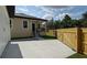View of backyard, back of the main house and the garage, and the concrete driveway at 7013 N 15Th St, Tampa, FL 33610