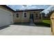 View of backyard, back of the main house and the garage, with new concrete patio at 7013 N 15Th St, Tampa, FL 33610