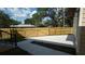Wide view of fenced backyard, with a view of the side of the house and a big shady tree at 7013 N 15Th St, Tampa, FL 33610
