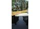 View of fenced backyard, new concrete, and black railing at steps from the home at 7013 N 15Th St, Tampa, FL 33610