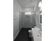 Modern bathroom featuring a glass shower with striking black and white patterned walls at 7013 N 15Th St, Tampa, FL 33610