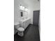 Modern bathroom featuring dual sinks, a gray door, and a clean, minimalist design at 7013 N 15Th St, Tampa, FL 33610