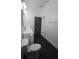 Bright bathroom featuring a dual sink vanity, gray door, and modern lighting fixtures at 7013 N 15Th St, Tampa, FL 33610