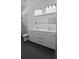 Bathroom featuring double sinks, modern lighting, and black tile floors at 7013 N 15Th St, Tampa, FL 33610