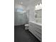 Modern bathroom featuring a glass shower, sleek white vanity, and contemporary fixtures at 7013 N 15Th St, Tampa, FL 33610