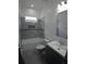 This bathroom has a vanity, mirror, toilet and tiled shower at 7013 N 15Th St, Tampa, FL 33610