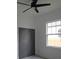 This bedroom has light colored floors, a window and a closet at 7013 N 15Th St, Tampa, FL 33610