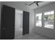 This bedroom features light colored floors, windows, and grey doors at 7013 N 15Th St, Tampa, FL 33610